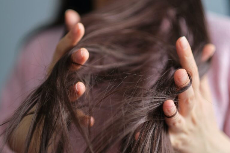 woman touches tangled dry hair. hair care in winter. Long Disheveled Hair, Holding Messy Hair